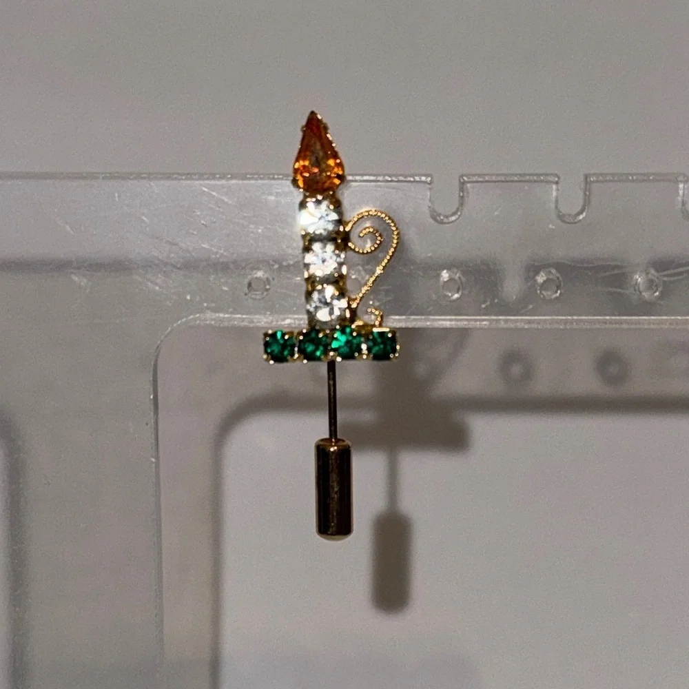Elegant Gold and Green Brooch with Candle Design